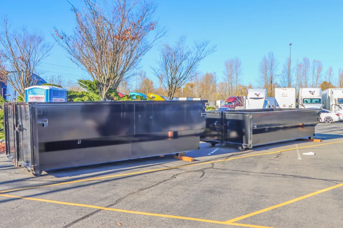 Professional dumpster rental service with roll-off container on residential driveway in South Gate Ridge